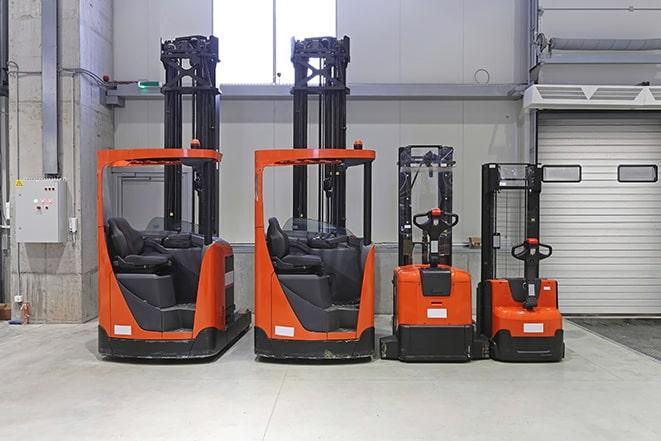 forklifts stacking pallets in a storage facility